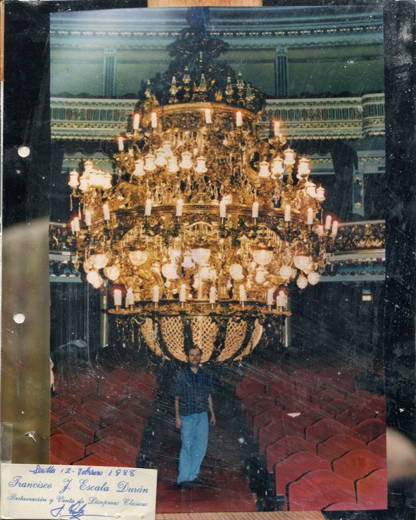 Artesano junto a la lámpara colosal ya restaurada en el Lope de Vega